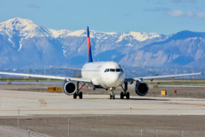Non-stop flights to SLC, plane on runway.